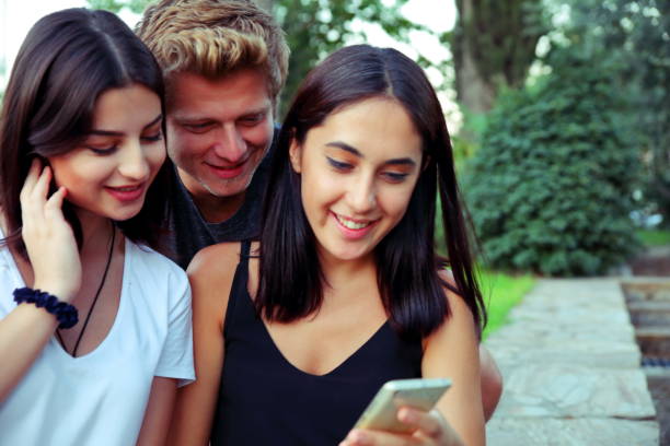 istock Young friends looking at the phone 919539106