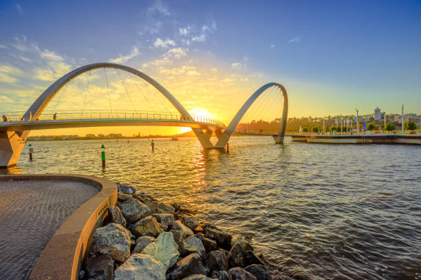 Elizabeth Quay Bridge sunset Scenic and iconic Elizabeth Quay Bridge at sunset light on Swan River at entrance of Elizabeth Quay marina. The arched pedestrian bridge is a new tourist attraction in Perth, Western Australia. perth australia photos stock pictures, royalty-free photos & images