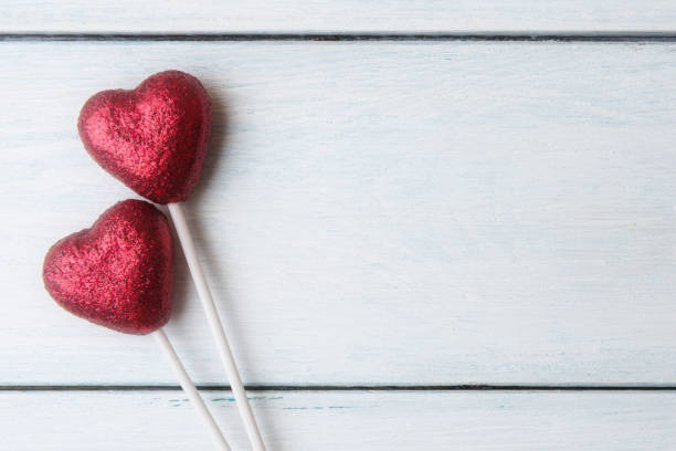 istock Red hearts over white wooden background with copy space 919551134