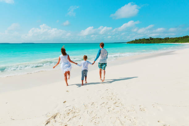 istock happy family with kid play run on beach 919551878