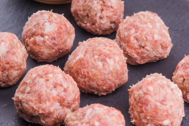 istock Fresh raw meat balls with dark background close-up 919551890