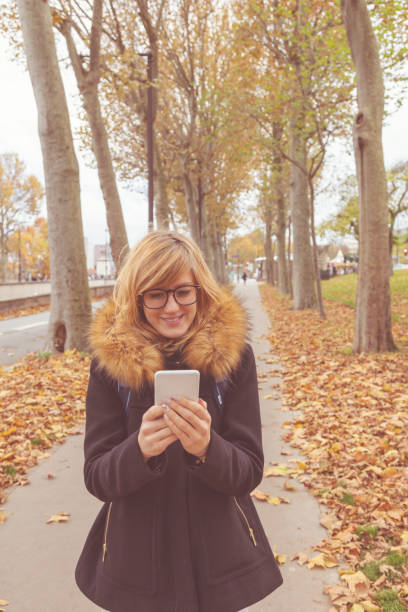 istock Cute girl using cellphone on the street. 919554554