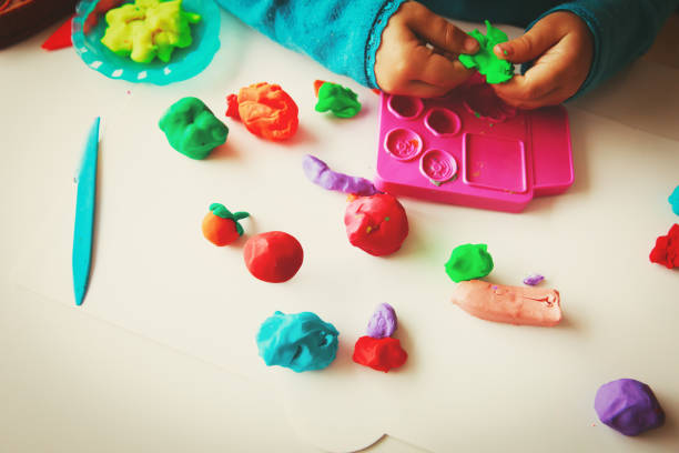 istock Child playing with clay molding shapes 919554734
