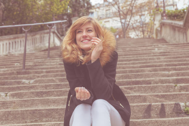 Cute smiley girl sitting alone on a big staircase.