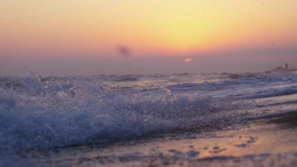 istock Waves at the beach in the evening at sunset 919555282