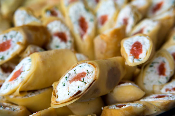 Pancakes filling white cheese, dill and red fish (salmon).