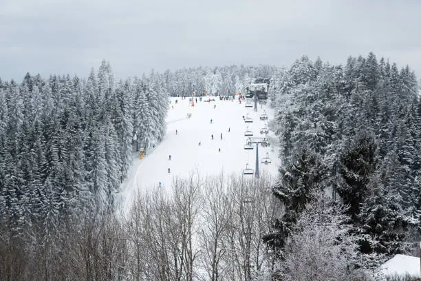 People skiing on the slopes of Winterberg, in Germany