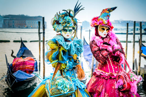 Venice, Italy - February 1, 2016: Attractive woman wearing a butterfly mask poses at the 2016 Venice Carnival.