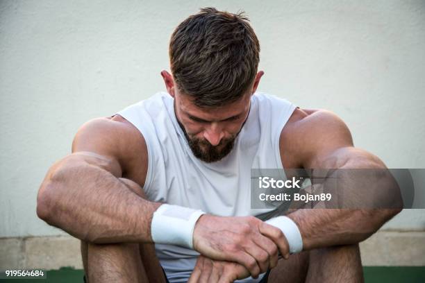 Tired Athletic Man Looking Down After Intensive Fitness Workout Stock Photo - Download Image Now