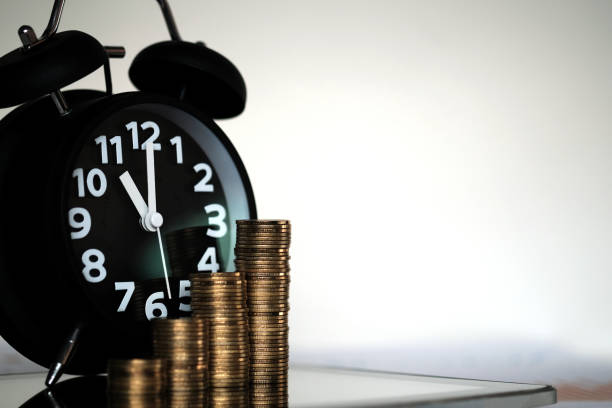 istock Step of coins stacks and alarm clock with tablet computer and financial graph, business planning vision and finance analysis concept. 919567436