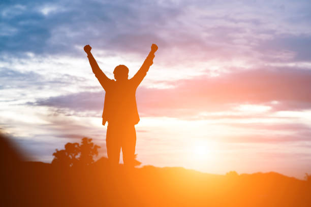 istock Raised arms man against beautiful sunset. 919573564