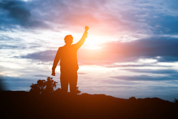 istock Raised arms man against beautiful sunset. 919573838