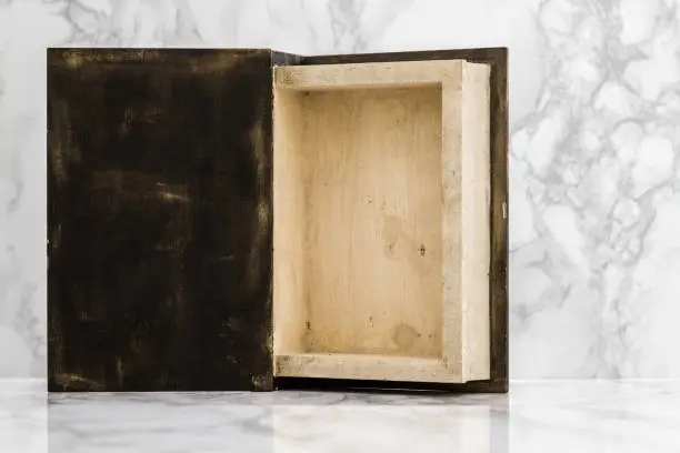 Inside of wooden box on white marble table