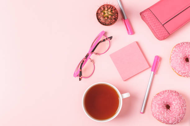 istock Cup of tea with donuts on a pink pastel background 919576690