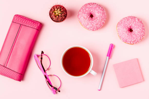 istock Cup of tea with donuts on a pink pastel background 919576780