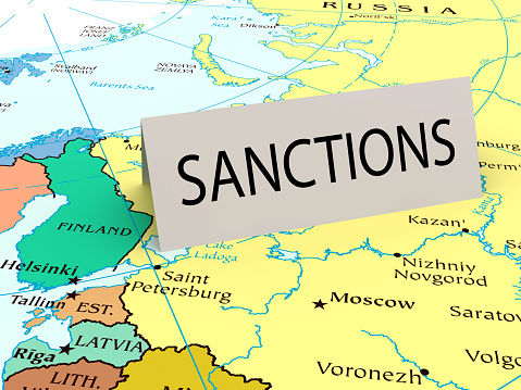 Sanctions paper card on map of Russia. As background used CIA Map that are in the public domain https://www.cia.gov/library/publications/resources/cia-maps-publications/