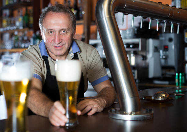 istock Barman is standing with golden beer 919580606