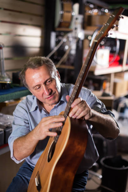 istock Man is repairing acoustic guitar 919580714