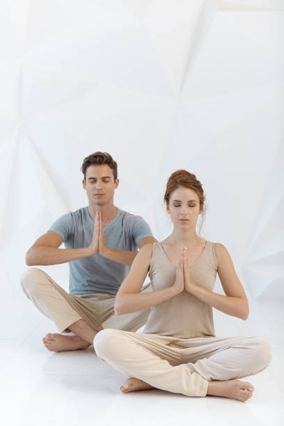 istock Young couple in yoga pose 919581184