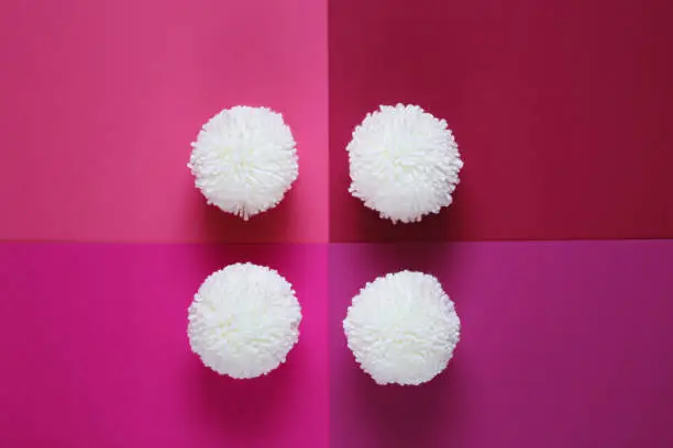 white pompons on pink mix geometric background