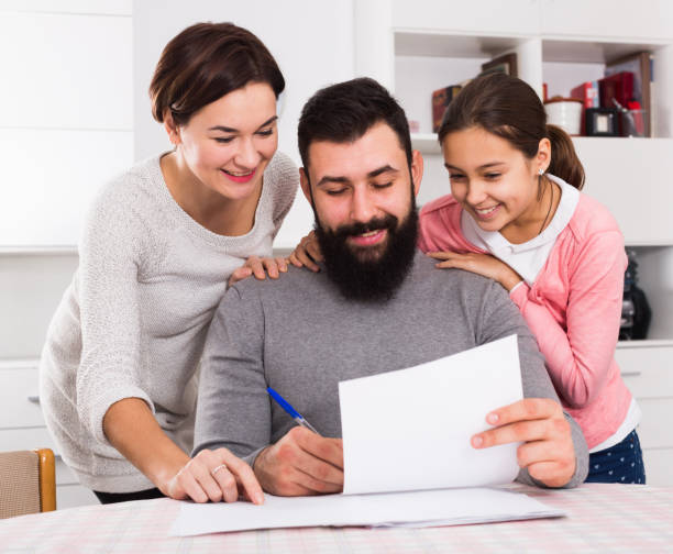 istock Parents signing property papers 919605188