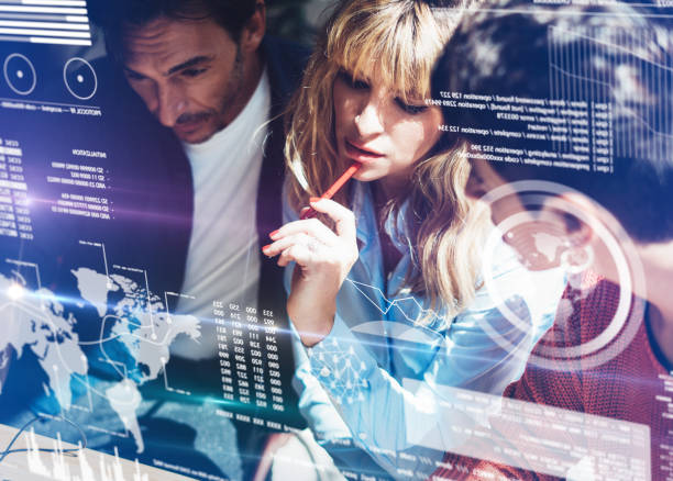 istock Coworking process in a sunny office.Young Business team making discussing at office.Concept of digital diagram,graph interfaces,virtual screen,connections icon.Horizontal,blurred background.Cropped. 919607654