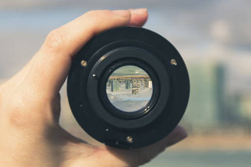 Multi-storey buildings and skyscrapers through a camera lens - image inside is inverted, urban landscape