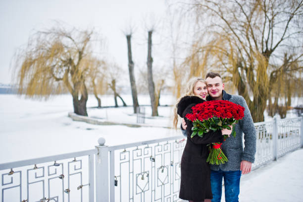 istock Married proposal with 101 rose at winter day. Loving couple. 919611332