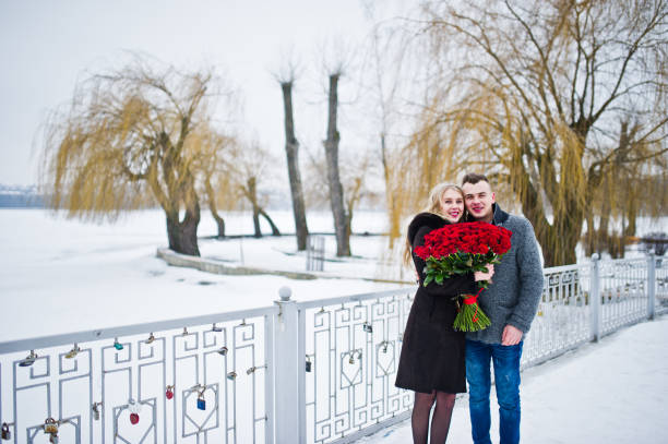 istock Married proposal with 101 rose at winter day. Loving couple. 919611358