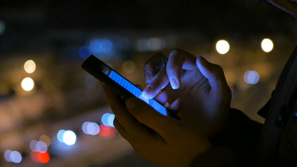 istock Young pretty woman using smartphone in the city at night 919616632