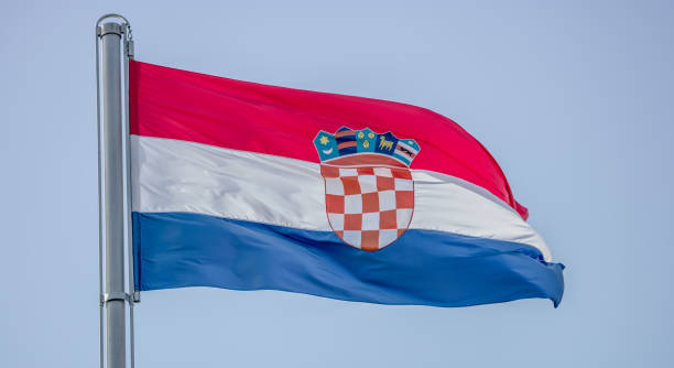 istock Croatian flag against blue sky 919631978