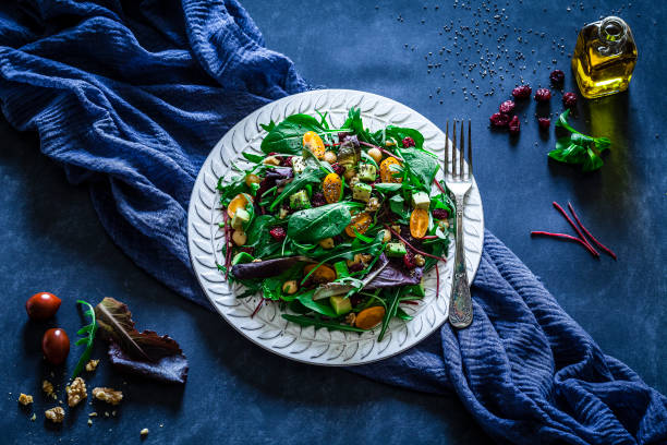istock Healthy fresh salad plate on bluish tint table 919632034
