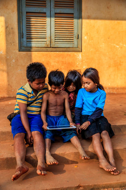 istock Happy Cambodian children using tablet on a schoolyard, Cambodia 919644434
