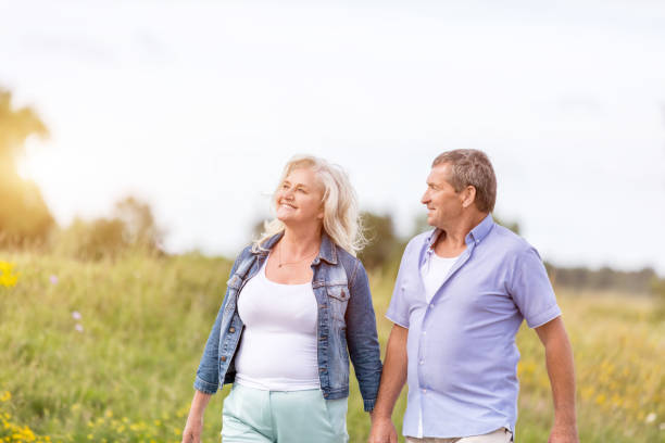 istock Man and woman holding hands, walking. 919644444