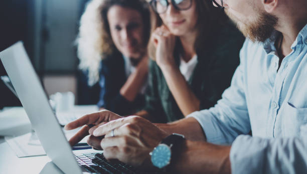 istock Concept of teamwork process at office.Young team working together at night modern office loft.Blurred background.Horizontal.Cropped. 919644832