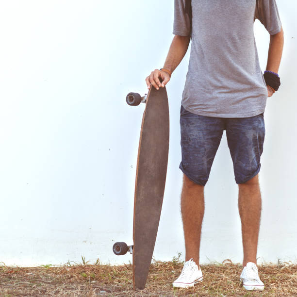 istock guy on skateboard at sunset near white wall 919645660