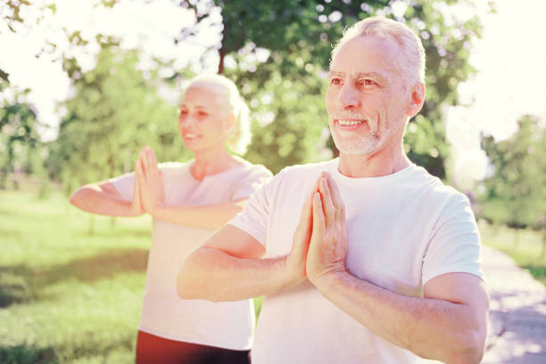 istock Positive elderly friends having meditation outdoors 919662172