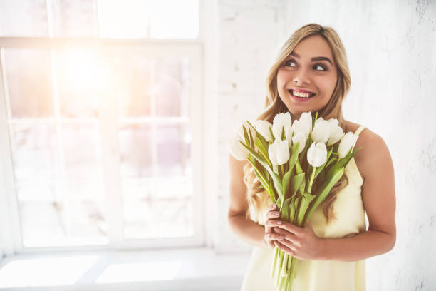 istock Young woman with tulips 919662852