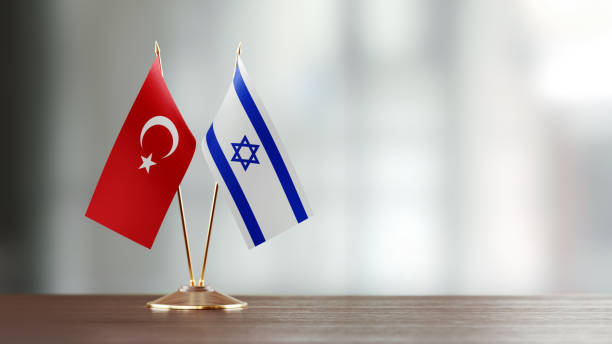 istock Turkish And Israeli Flag Pair On A Desk Over Defocused Background 919666732