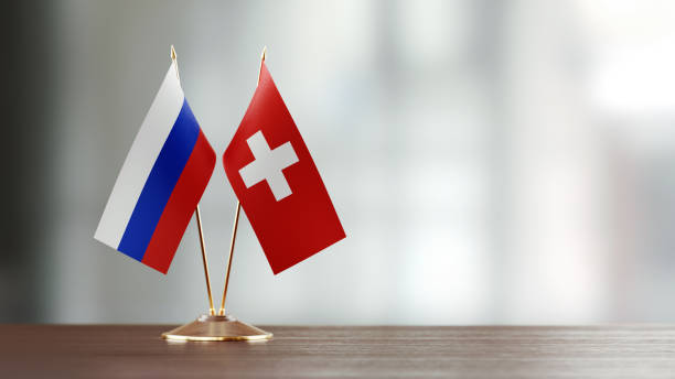 istock Russian And Swiss Flag Pair On A Desk Over Defocused Background 919667252
