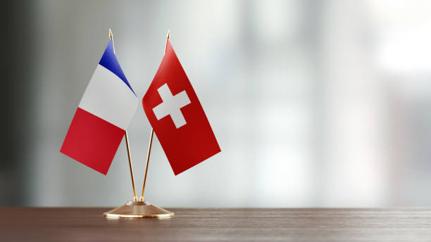 istock French And Swiss Flag Pair On A Desk Over Defocused Background 919667858