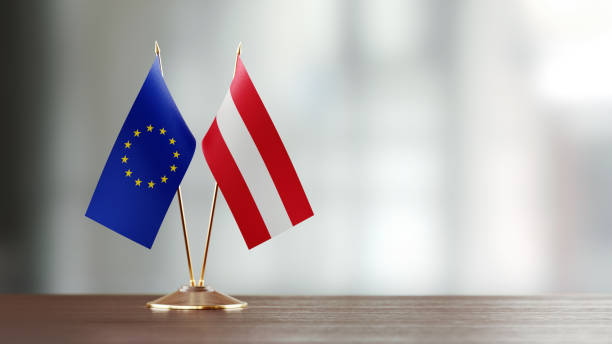 istock European Union And Austrian Flag Pair On A Desk Over Defocused Background 919677946