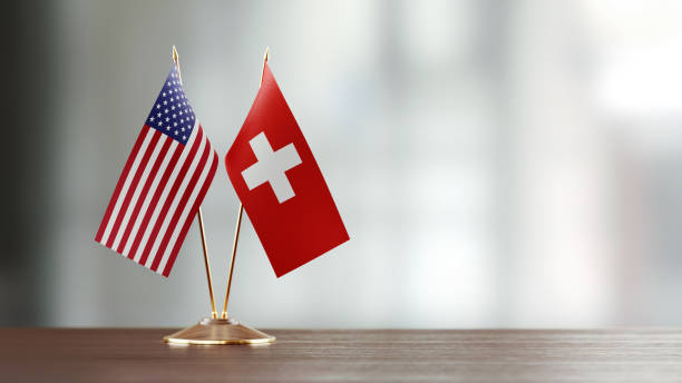 istock American And Swiss Flag Pair On A Desk Over Defocused Background 919694904