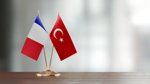 istock French And Turkish Flag Pair On A Desk Over Defocused Background 919699120