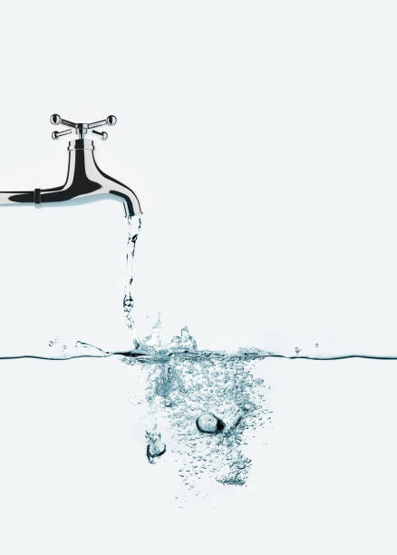 istock splash of water pouring from faucet 919705480