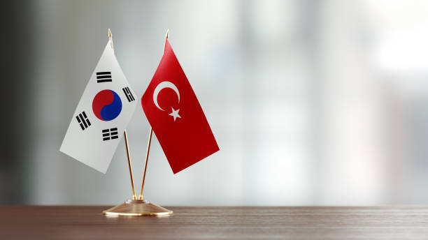 istock South Korean And Turkish Flag Pair On A Desk Over Defocused Background 919711896