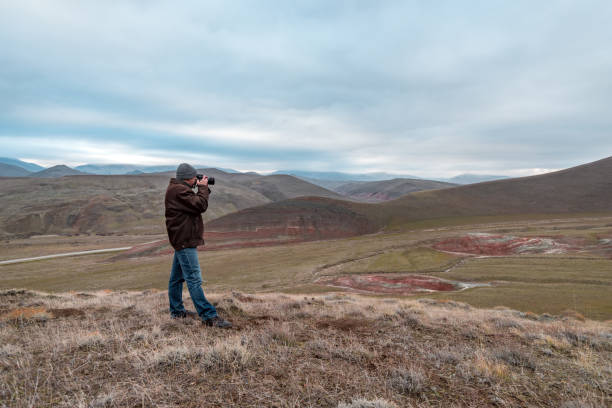 istock Nature photographer in red mountains 919732348