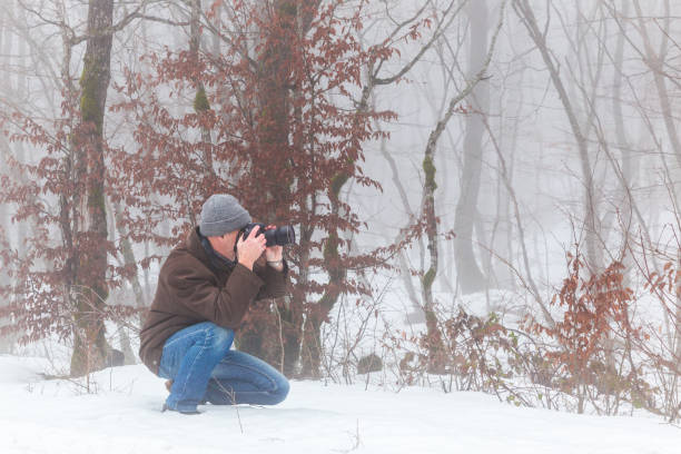 istock Nature photographer in winter forest 919732438