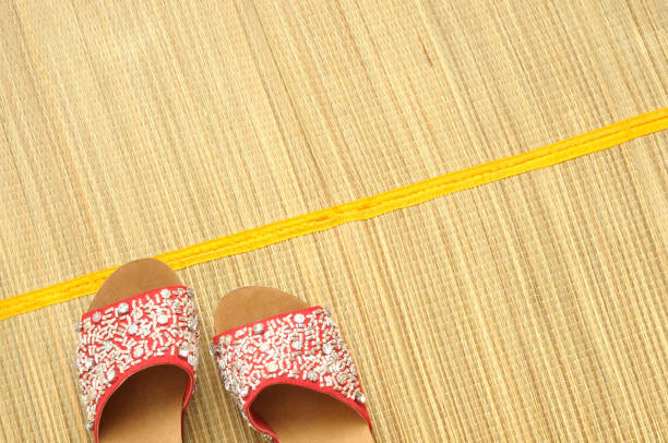 Red  sandals on a bamboo mat, concept for summer, top view, large copy space
