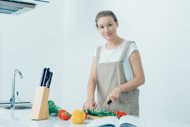 istock Calm young woman making favorite recipe 919778440